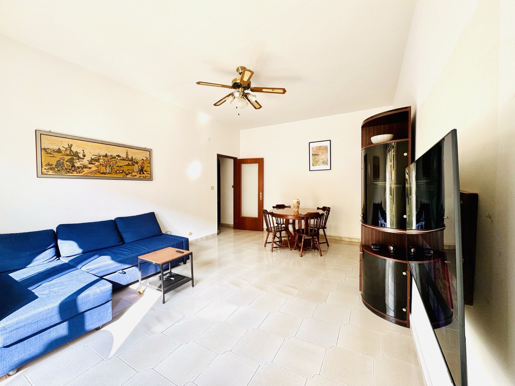 The bright living room with sofa and dining area