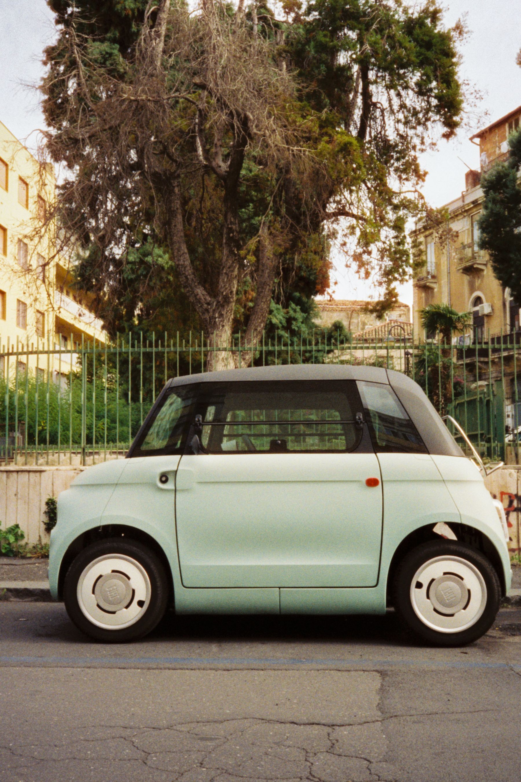 A compact car parked on a narrow Sicilian street