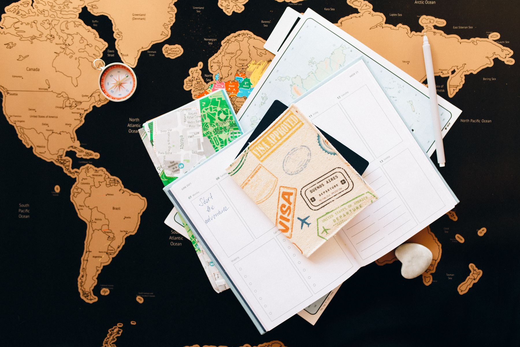 Passport, map and travel planner prepared for a holiday