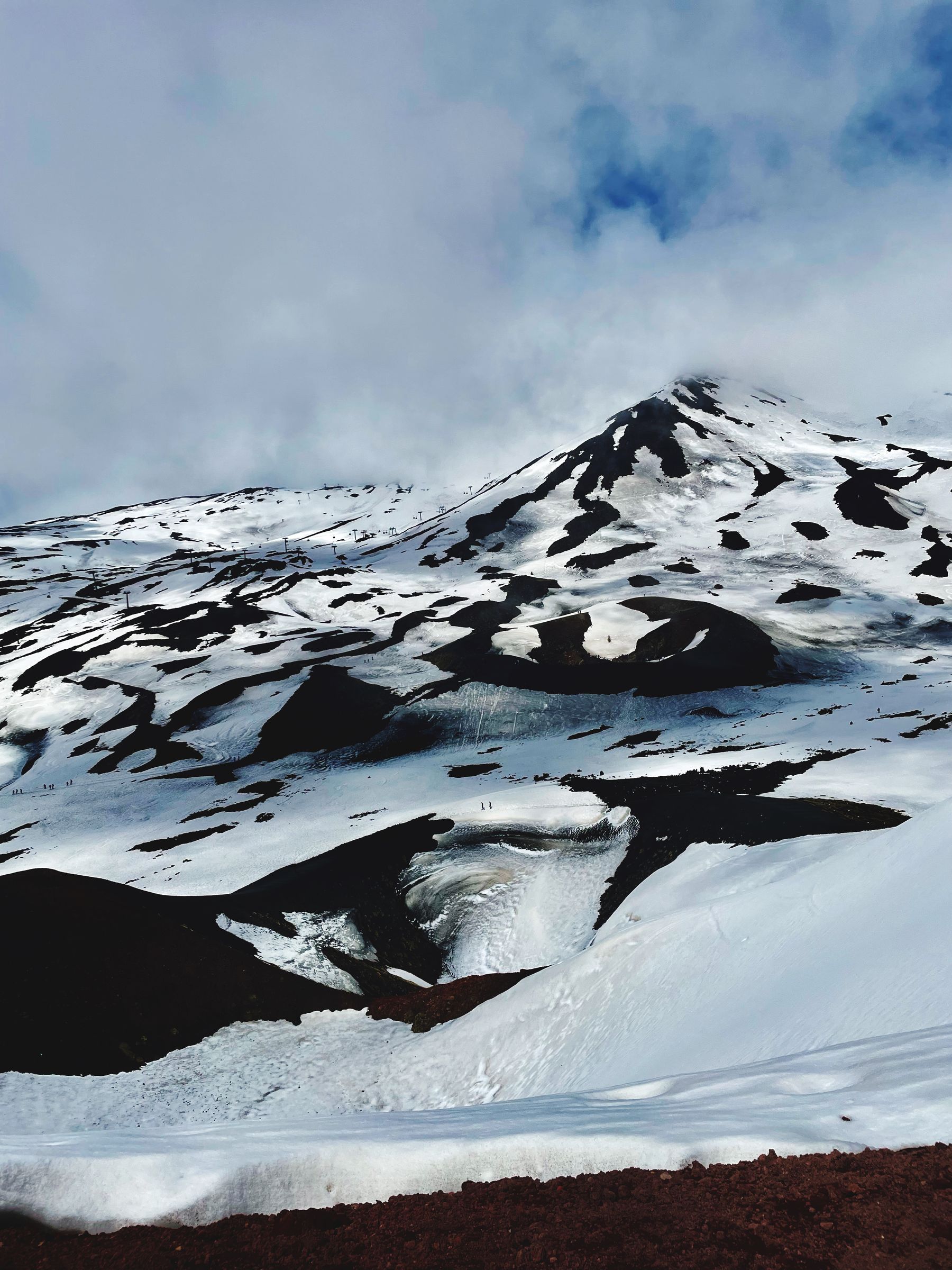 Snow on Mount Etna beneath heavy winter clouds