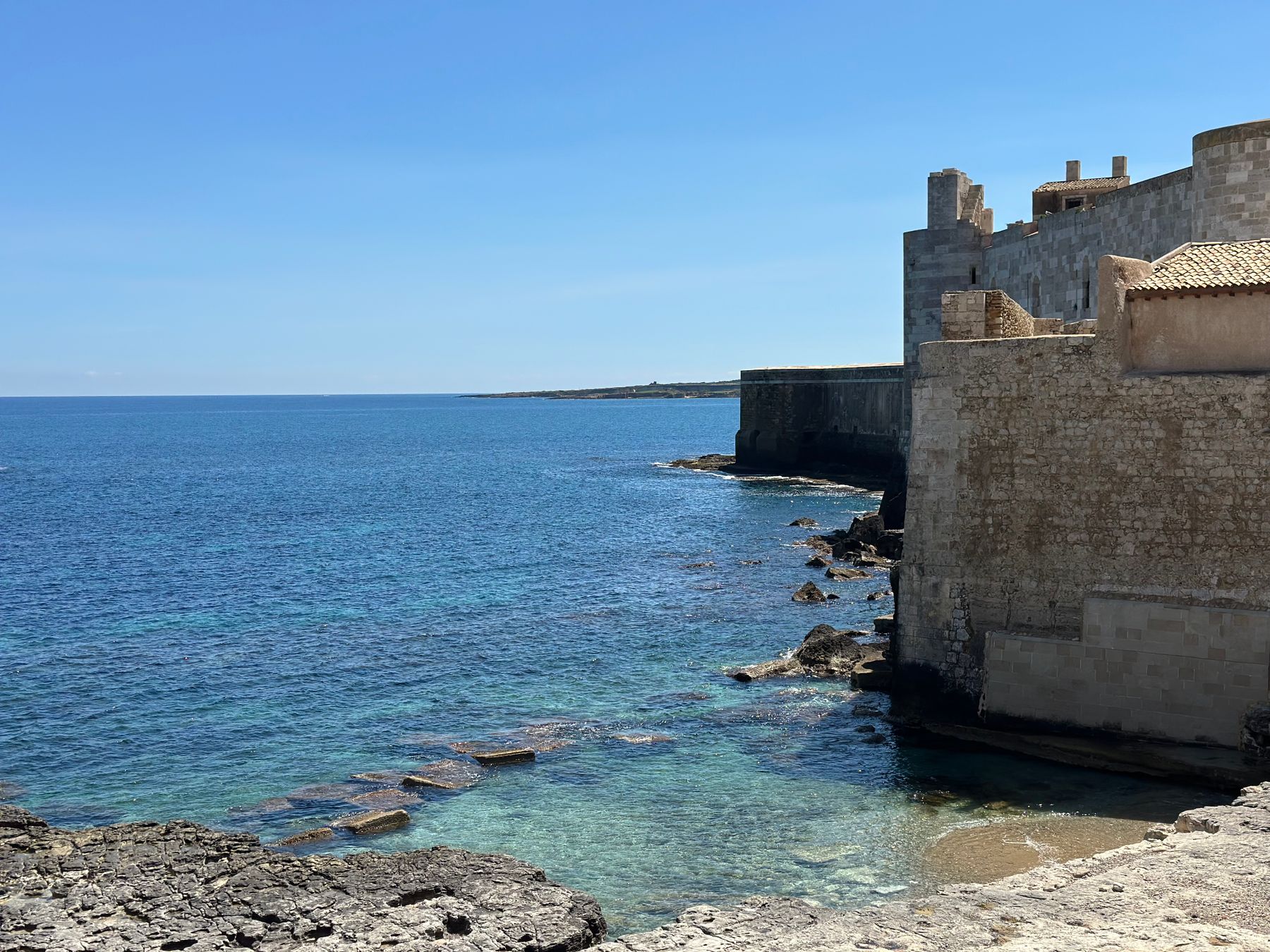Ortigia’s historic waterfront seen from the water at Syracuse